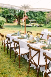 Long reception tables set on the lawn under the trees