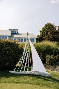 White sailboat display on the lawn at a coastal Maine wedding planned by Coastline Weddings
