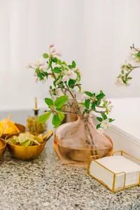 Delicate greenery in a glass vase on the cocktail table