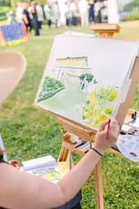 Live painter capturing the reception on canvas