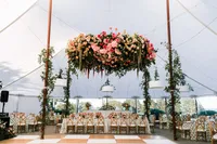 Floral chandelier suspended inside the reception tent