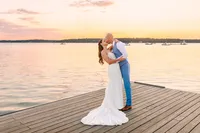 Couple kissing on the dock at sunset on Casco Bay