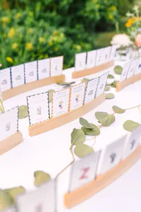 Escort cards lined up with greenery