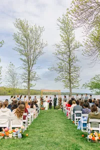Guests seated on the lawn for a waterfront ceremony in Winterport, Maine