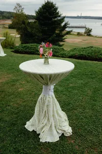 Cocktail table draped in white linen on the lawn