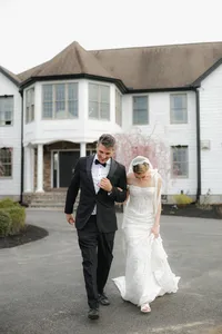Couple walking through historic Massachusetts wedding venue captured with an editorial and candid approach
