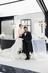 Couple sitting on top of a luxury wedding bar in a high end event space in new england