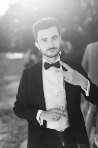 Témoin en smoking profitant d’une réception de mariage à Nantes, portrait éditorial en noir et blanc.