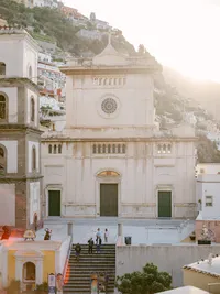 Sunlit view of Santa Maria Assunta Church in Positano, an iconic wedding ceremony location on the Amalfi Coast.