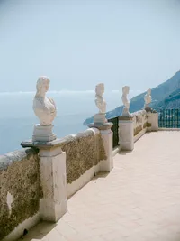 Scenic terrace at Villa Cimbrone in Ravello with marble busts overlooking the Mediterranean — iconic setting for Amalfi Coast weddings.