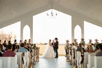 a bride and groom stand hand in hand chandelier farms chapel in terrel, texas