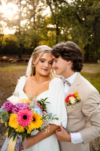 a groom leans into his bride during their couples portraits