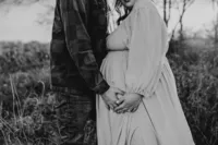 a husband cradles his pregnant wifes belly during their maternity session in mckinney,tx