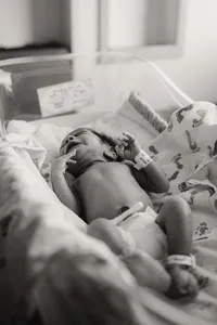 a fresh new baby lays in his hopsital bassinet at plano presby.