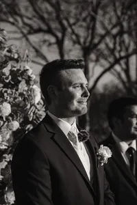 a groom sheds a tear watching the bride walk down the iasle at their castle wedding