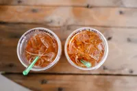 a close up photo of the bride and grooms dutch bros drinks