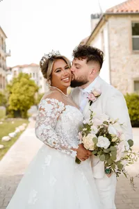 a groom kisses his bride at the bella donna chapel in mckinney texas.