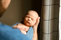 a photo of a baby boy and his dad during his newborn session with shelly voss in ft.worth, texas