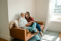a family cuddles on the couch during their newborn session at studio house in mckinney,tx