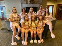 bridal party in pjs by fireplace