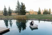 Newly wed couple photos on a boat at Pine and Pond wedding venue in Alberta