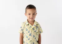 A shy young boy smiling softly in his school portrait.