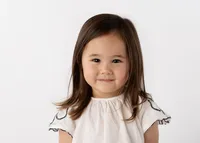 Cute preschool aged girl with a soft smile for school pictures.