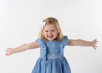smiling-blonde-preschool-girl-with-arms-outstretched