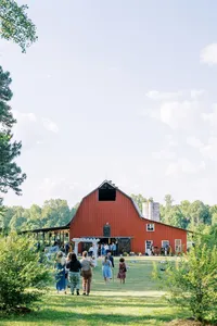 A lovely spring wedding at Cates Farm at Cane Creek in Durham, North Carolina, featuring a classic outdoor ceremony beside cornfields and a timeless red barn under beautiful Carolina skies, captured by North Carolina wedding photographer Jessica Leigh Mason.