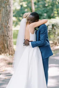 A couple embraces in a fine art style with true-to-life colors during their wedding at Pine Spruce Lodge in Bahama, North Carolina, captured by Jessica Leigh Photography.