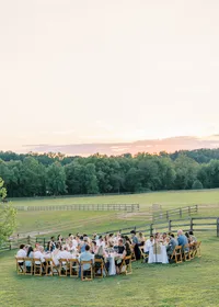 A scenic view of a wedding reception set on the rolling hills at Lucky Dog Farm backyard wedding, captured with natural warmth by Jessica Leigh Photography.