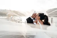 Bride and groom kissing under the veil during their Sergeants Mess wedding