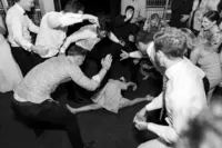 A little girl doing the splits on the dance floor at a Sydney wedding
