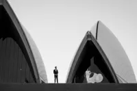 Bride and groom standing infron of the Sydney Opera House
