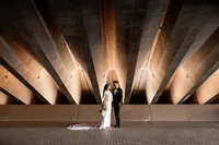 Bride and groom standing underneath the Sydney Opera House