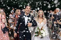The couple doing their ceremony exit as confetti is thrown in the air