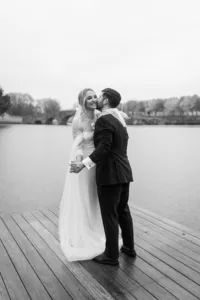 A black and white photo of a groom kissing his bride on the cheek. Captured by Hunter Valley Wedding Photographer Lonley Hunter