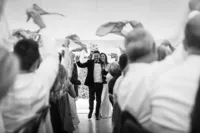 Bride and groom walking into their reception