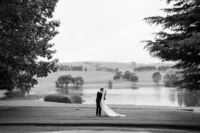 A bride and groom having a moment together in front of some beautiful scenery at their wedding