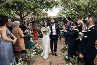 Confetti being thrown in the air as the couple exit their ceremony