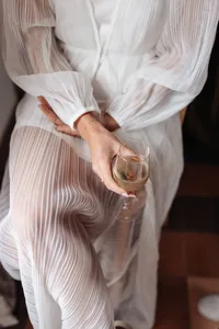 Bride holding a glass of wine on the morning of her Sydney wedding