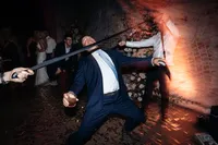A guest doing limbo under a tie on the dance floor at Events By Alpha on Castlereagh Street in Sydney City