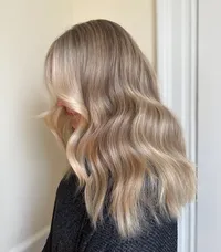 gorgeous mid-length dimensional blonde hair in cascading waves at Moxie Hair Studio