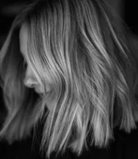 a black and white image close up of a freshly lightened and cut bob