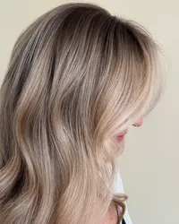 a rooted blonde hair look with the image cropped in to really capture the overall dimension and brightness around the face at Moxie Hair Studio
