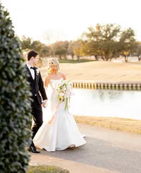 mermaid strapless wedding dress on a woman walking down a sidewalk by the river