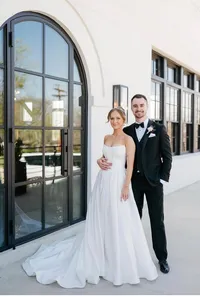 Man and wife in a strapless wedding dress after the wedding