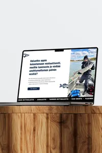 Website design for a fishing company displayed on a laptop.