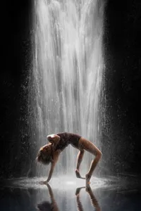 A modern dance student from Germantown High School poses in a backbend with an A.I. waterfall cascading upon her for this artistic portrait in her senior year.
