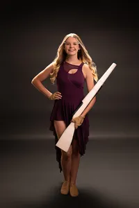 A member of the Arrowhead drill team poses for her senior portraits in our Waukesha studio wearing her uniform.